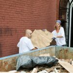 Two people working together on a community cleanup project